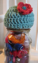 A pin cushion on the lid of a mason jar. If you`re bored, you can stare REALLY hard and try to see the needle in the cushion.